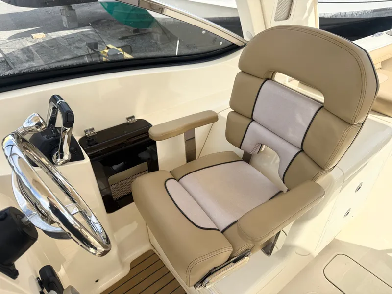 Slide: The Image of Interior of a 2015 Scout 275 Dorado boat with steering wheel and seat. - 20