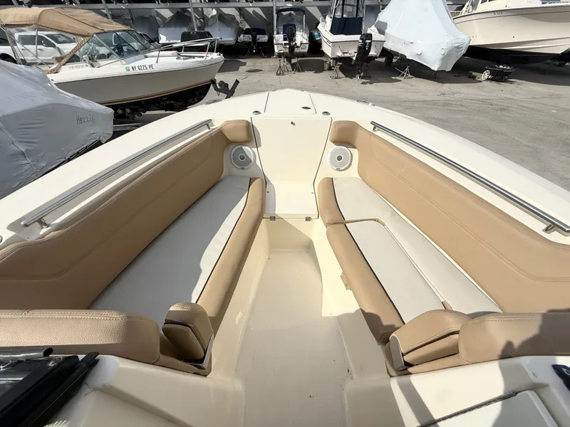 Slide: The Image of Interior view of a 2015 Scout 275 Dorado boat with beige seating. - 24