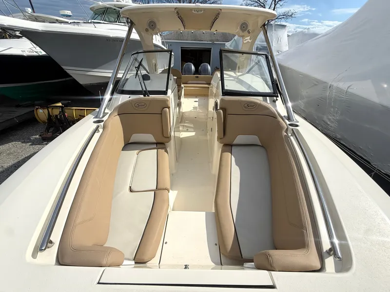 Slide: The Image of Interior view of a 2015 Scout 275 Dorado boat with beige seating. - 25
