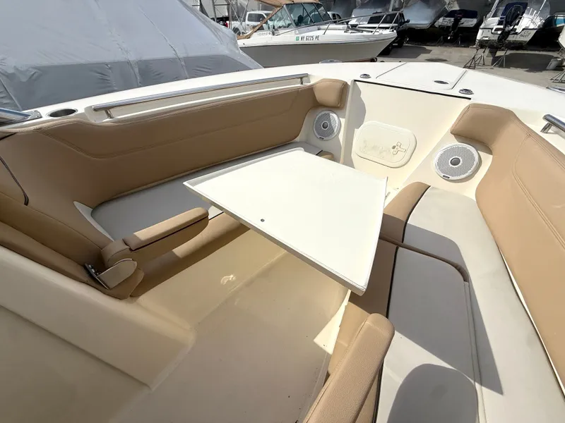 Slide: The Image of Interior of a 2015 Scout 275 Dorado boat with seating area and table. - 26