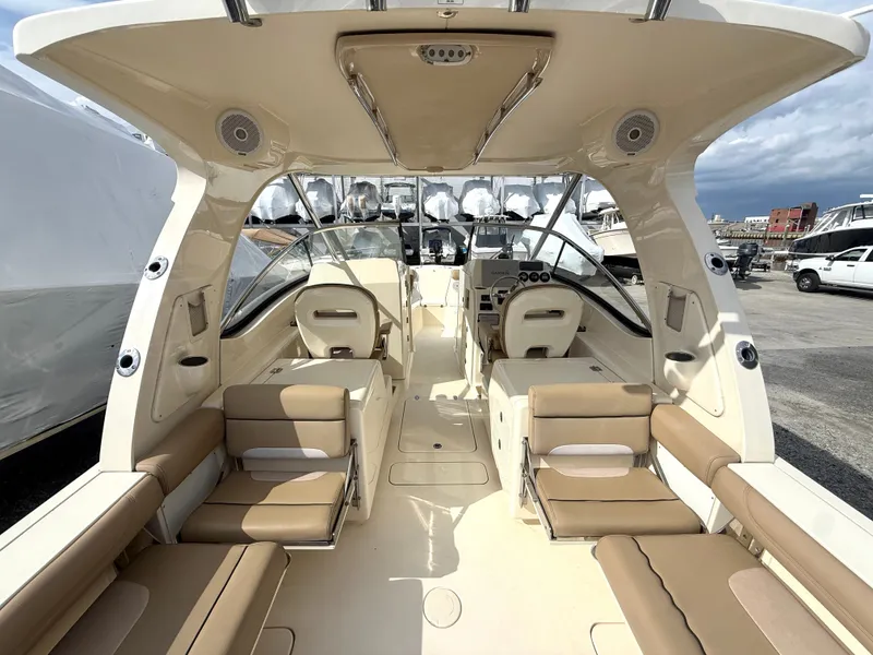 Slide: The Image of Interior view of a 2015 Scout 275 Dorado boat with beige seating. - 9