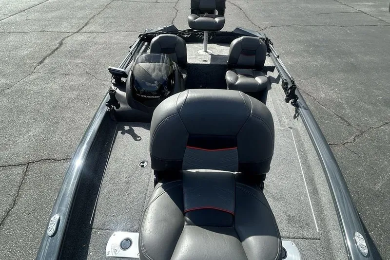 Slide: The Image of 2022 Tracker Pro Team 175 TF boat interior with black seating and steering console. - 13