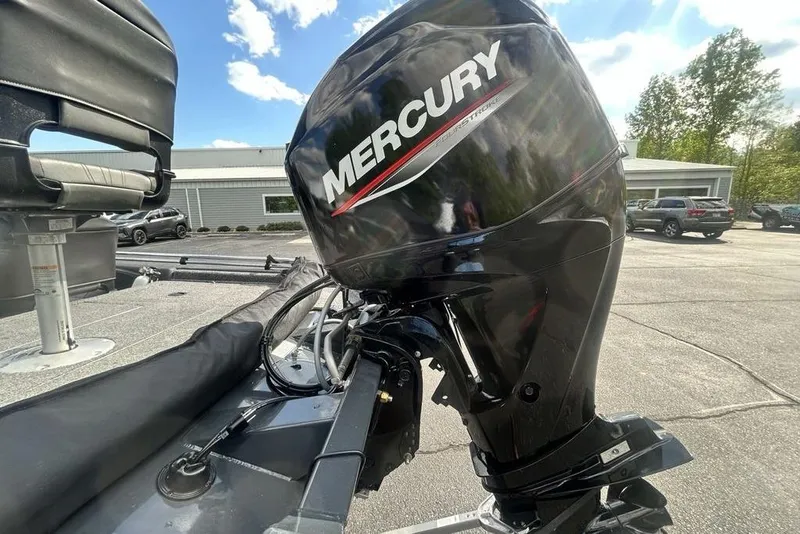 Slide: The Image of 2022 Tracker Pro Team 175 TF boat with Mercury outboard motor in a parking lot. - 17