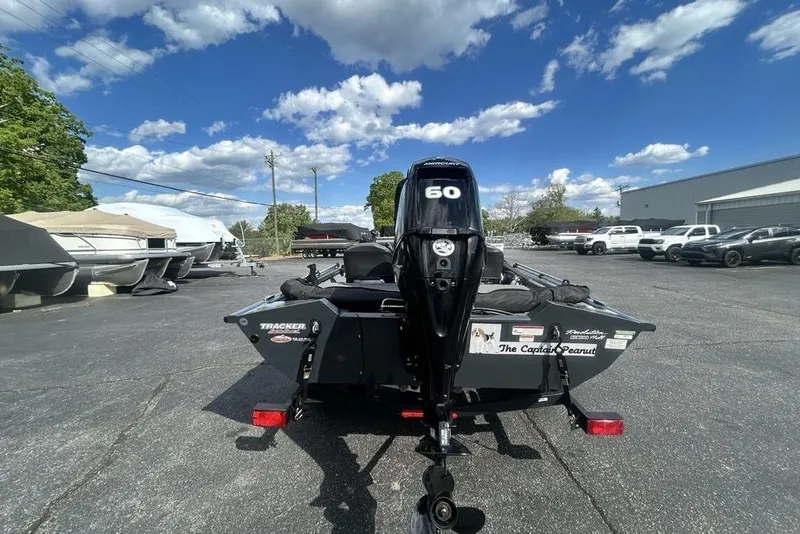 Slide: The Image of 2022 Tracker Pro Team 175 TF boat with 60 HP motor in a parking lot. - 18