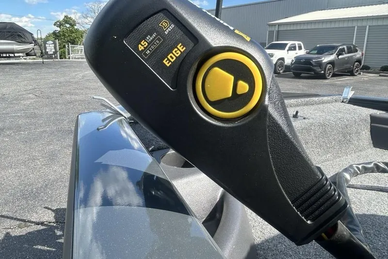 Slide: The Image of Close-up of a 2022 Tracker Pro Team 175 TF boat control panel outdoors. - 3