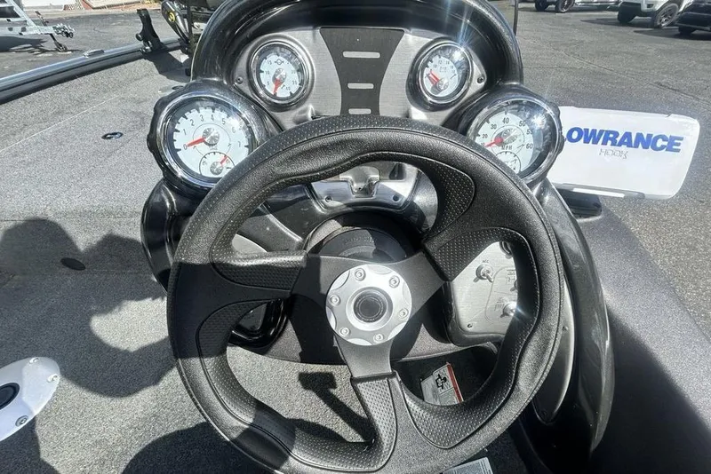 Slide: The Image of 2022 Tracker Pro Team 175 TF dashboard with steering wheel and gauges in sunlight. - 7