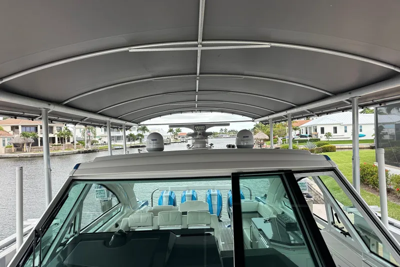 Slide: The Image of 2024 Formula 400 Super Sport Crossover docked under a covered marina. - 10