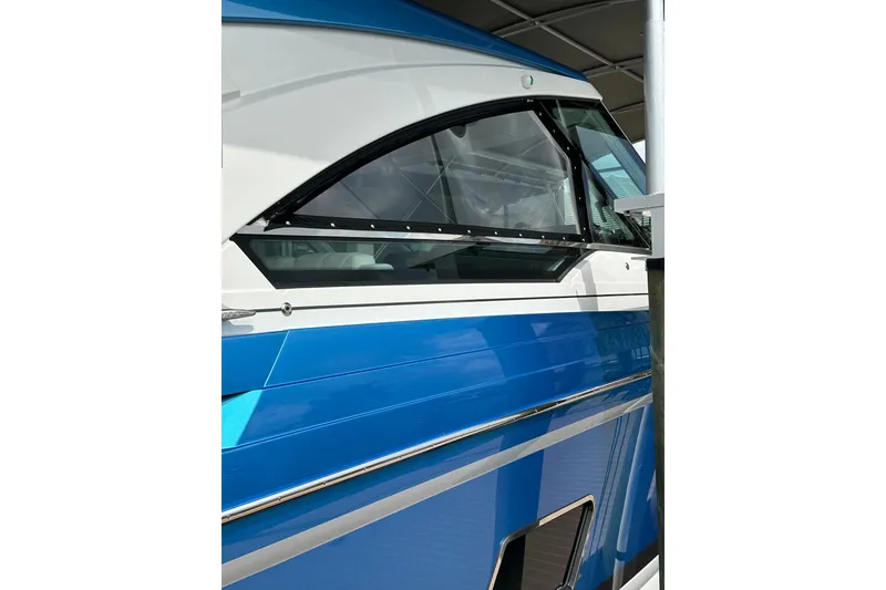 Slide: The Image of 2024 Formula 400 Super Sport Crossover boat with sleek blue and white design. - 11