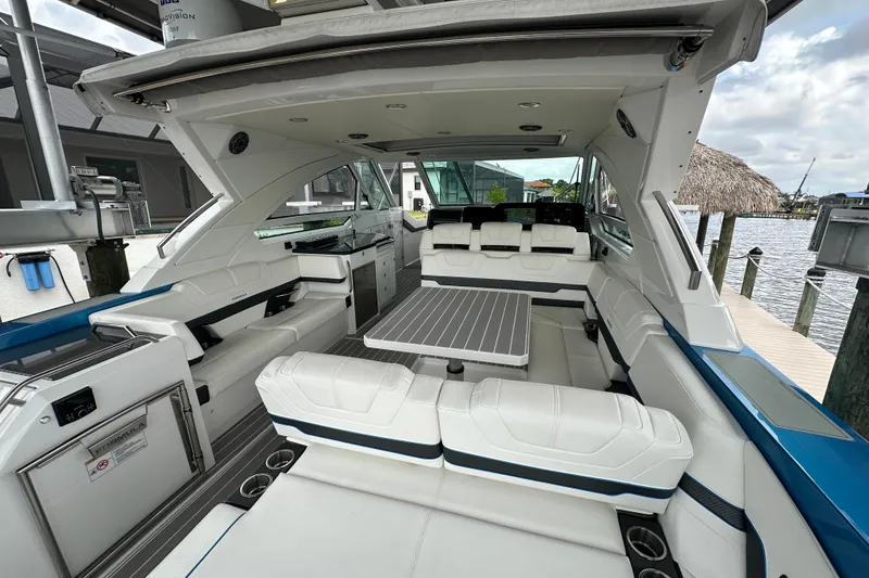 Slide: The Image of 2024 Formula 400 Super Sport Crossover luxury boat interior with white seating and table. - 14