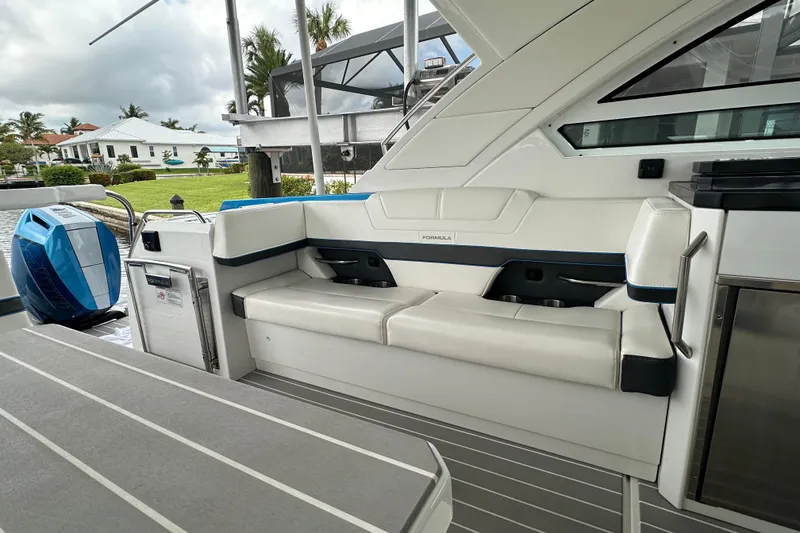 Slide: The Image of 2024 Formula 400 Super Sport Crossover boat interior with white seating and modern design. - 26