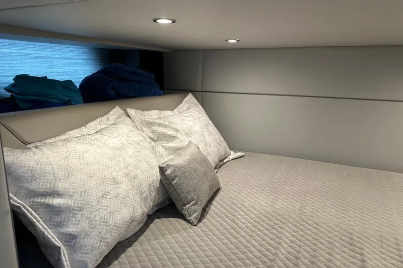 Slide: The Image of 2024 Formula 400 Super Sport Crossover cabin with cozy bedding and soft lighting. - 30