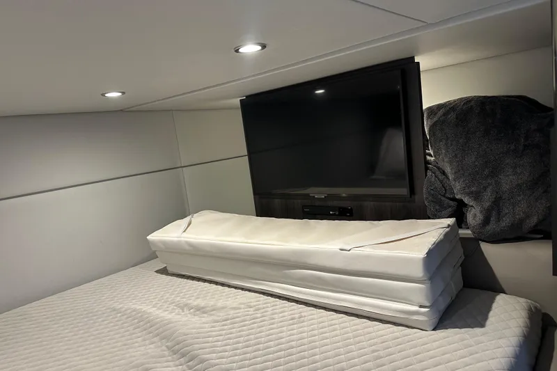 Slide: The Image of 2024 Formula 400 Super Sport Crossover cabin interior with TV and bedding. - 31