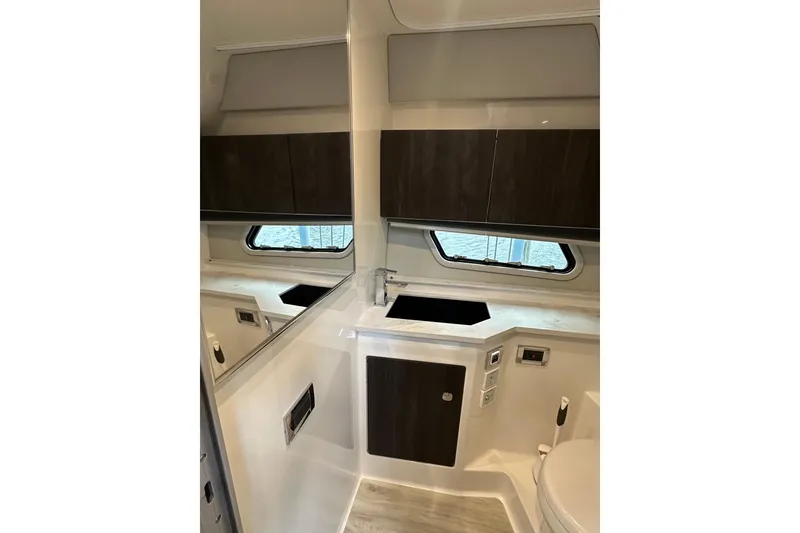 Slide: The Image of Interior of 2024 Formula 400 Super Sport Crossover boat, featuring modern bathroom design. - 36