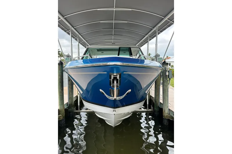 Slide: The Image of 2024 Formula 400 Super Sport Crossover boat docked under canopy. - 7