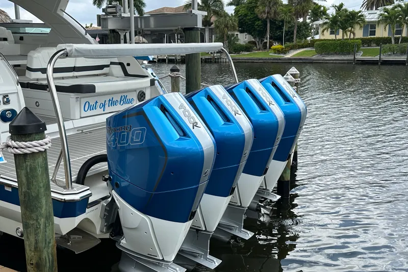 Slide: The Image of 2024 Formula 400 Super Sport Crossover with four blue outboard motors docked by water. - 8