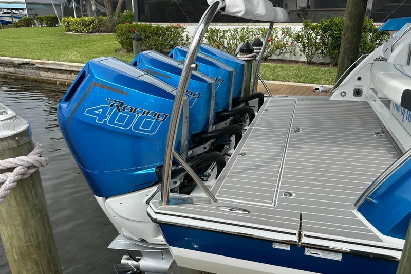 Slide: The Image of 2024 Formula 400 Super Sport Crossover with triple Racing 400 outboard engines docked. - 9