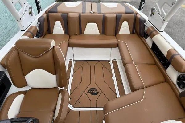 Slide: The Image of 2020 Malibu Wakesetter 21 VLX interior with brown and white seating, stylish design. - 10