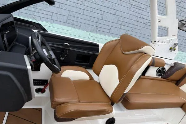 Slide: The Image of 2020 Malibu Wakesetter 21 VLX interior with brown and white seating, modern dashboard. - 11