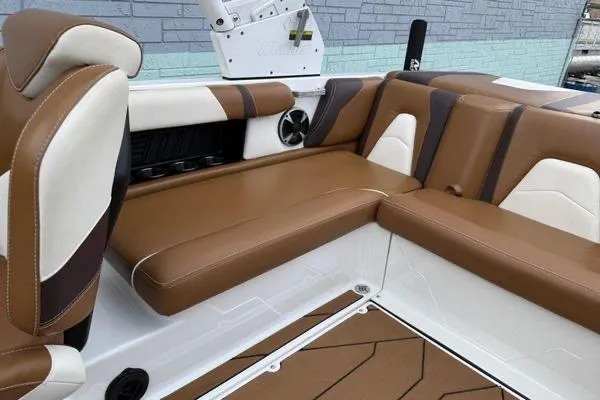 Slide: The Image of 2020 Malibu Wakesetter 21 VLX interior with brown and white seating, modern design. - 12