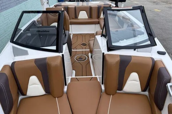 Slide: The Image of 2020 Malibu Wakesetter 21 VLX interior with brown and white seating, open windshield. - 7