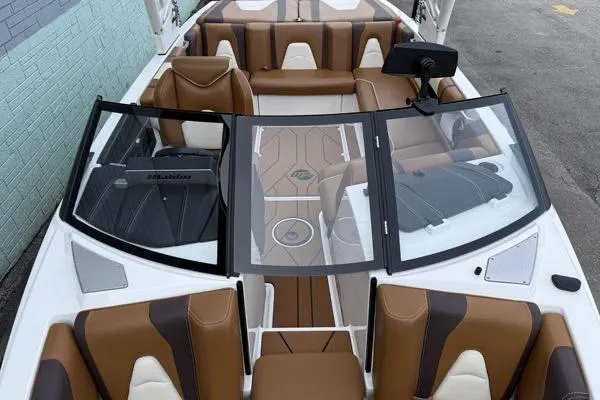 Slide: The Image of 2020 Malibu Wakesetter 21 VLX boat interior with brown and white seating. - 8