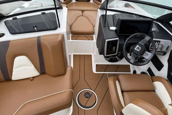 Slide: The Image of 2020 Malibu Wakesetter 21 VLX interior with brown and white seating, modern dashboard, and steering wheel. - 9