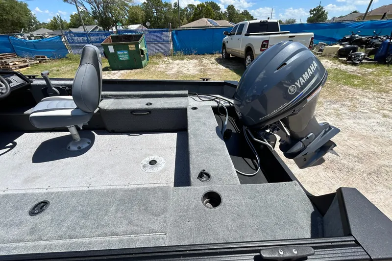 Slide: The Image of 2023 Alumacraft Escape 165 SC boat with Yamaha outboard motor, parked outdoors. - 10