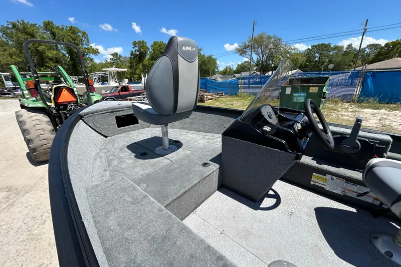 Slide: The Image of 2023 Alumacraft Escape 165 SC boat interior with steering console and seating. - 11