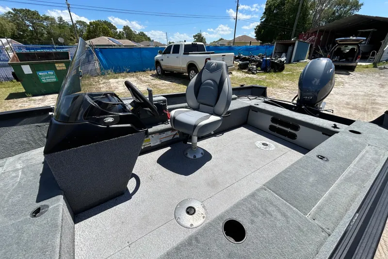 Slide: The Image of 2023 Alumacraft Escape 165 SC boat interior with steering console and seating. - 13