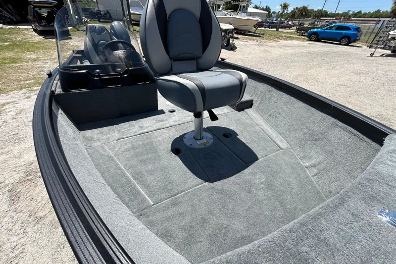 Slide: The Image of 2023 Alumacraft Escape 165 SC boat interior with gray seating and carpeted flooring. - 3