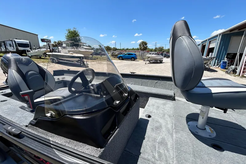 Slide: The Image of 2023 Alumacraft Escape 165 SC boat interior with steering console and seating. - 4