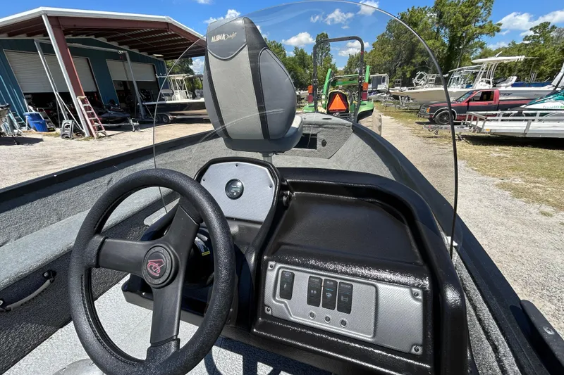 Slide: The Image of 2023 Alumacraft Escape 165 SC boat interior with steering wheel and control panel. - 5