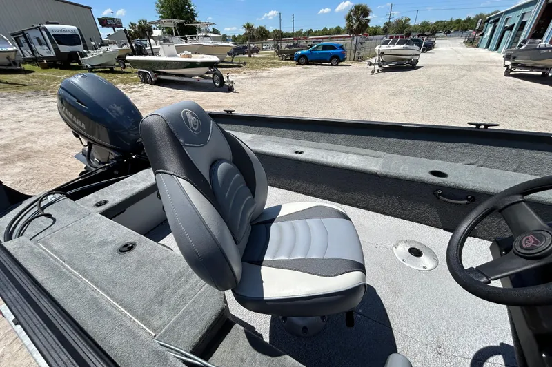 Slide: The Image of 2023 Alumacraft Escape 165 SC boat interior with Yamaha motor, featuring a comfortable seat. - 6