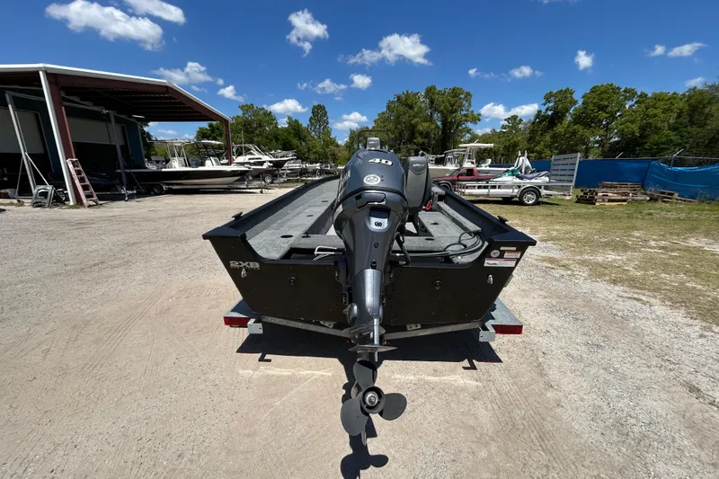 Slide: The Image of 2023 Alumacraft Escape 165 SC boat with outboard motor in a sunny outdoor setting. - 8
