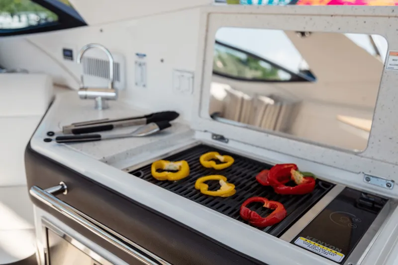 Slide: The Image of Grill on Sea Ray Sundancer 320 Outboard with bell pepper slices, 2026 model. - 18