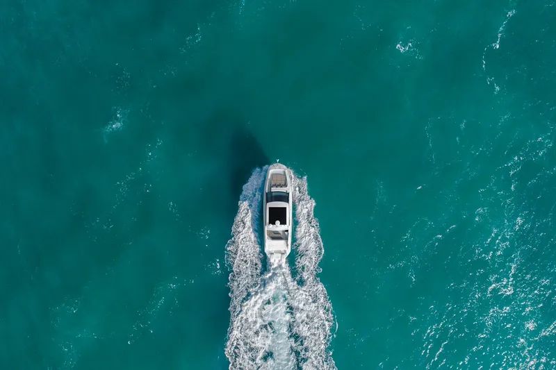 Slide: The Image of Aerial view of Sea Ray Sundancer 320 Outboard 2026 on blue water. - 7