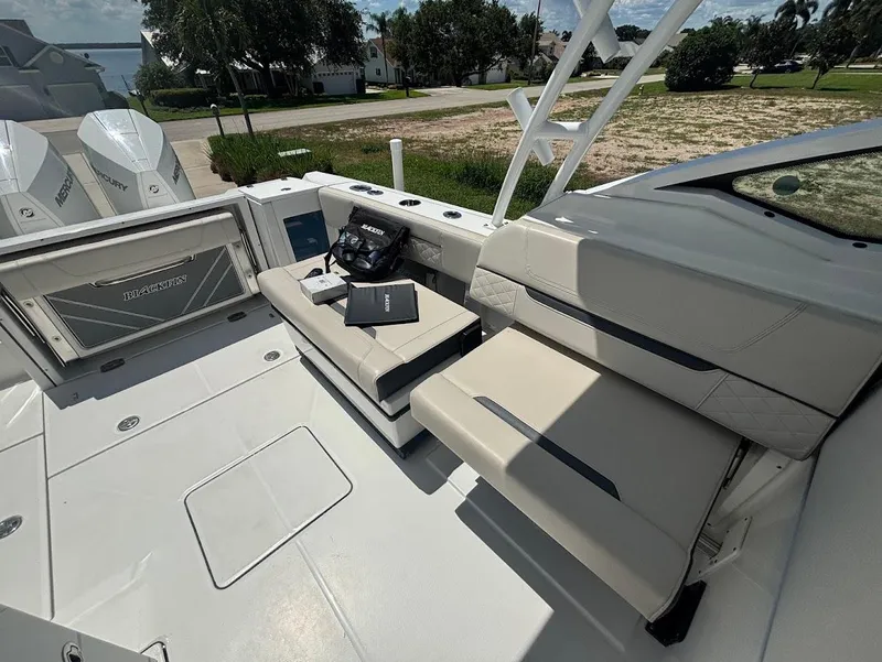 Slide: The Image of Interior of a 2021 Blackfin 272 DC boat with beige seating. - 12