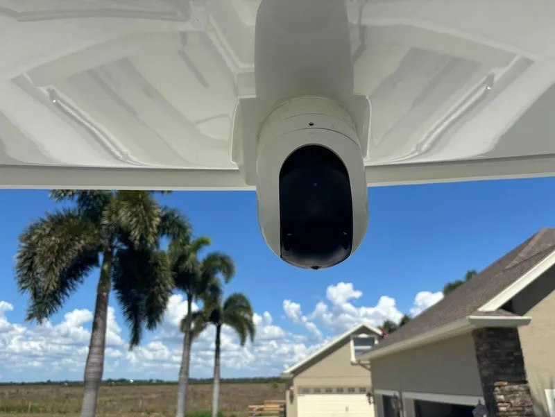 Slide: The Image of Blackfin 272 DC 2021 camera under boat roof, palm trees in background. - 19