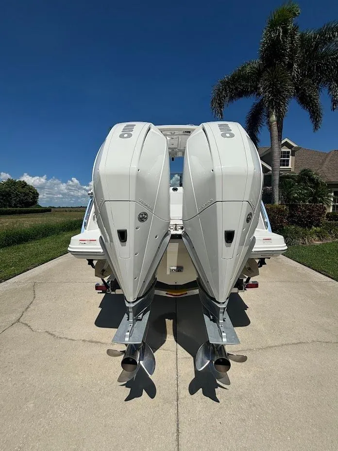 Slide: The Image of Rear view of 2021 Blackfin 272 DC with twin outboard engines. - 21
