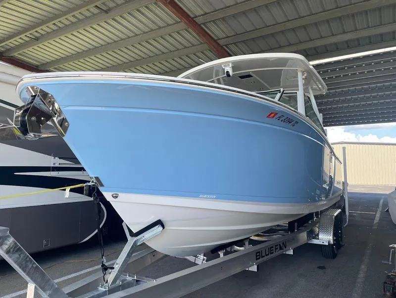 Slide: The Image of 2021 Blackfin 272 DC boat in blue on trailer. - 25