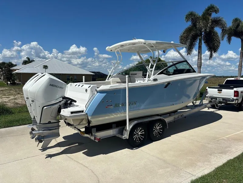 Slide: The Image of 2021 Blackfin 272 DC boat on trailer, sunny day, palm trees in background. - 3