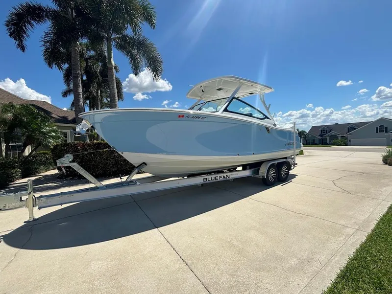 Slide: The Image of 2021 Blackfin 272 DC boat on trailer under palm trees. - 5