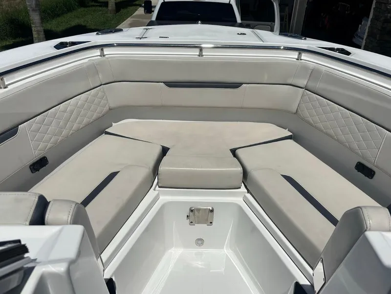 Slide: The Image of Interior of a 2021 Blackfin 272 DC boat with cushioned seating. - 6