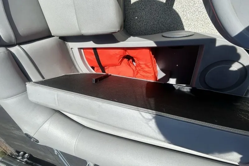 Slide: The Image of Storage compartment in a 2021 Bennington 20 SFX boat, featuring a life jacket. - 14