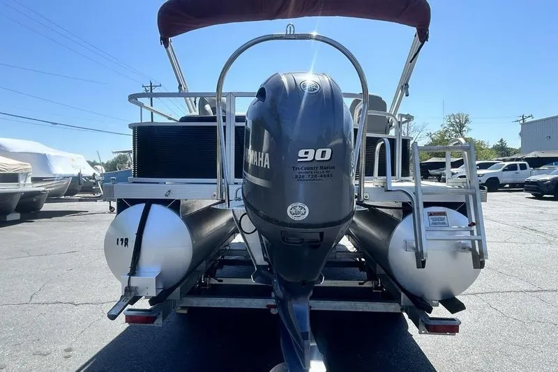 Slide: The Image of 2021 Bennington 20 SFX pontoon boat with Yamaha 90 engine, parked outdoors. - 16