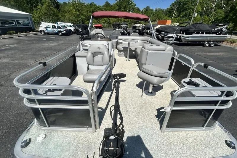 Slide: The Image of 2021 Bennington 20 SFX pontoon boat with seating, parked outdoors in a lot. - 3