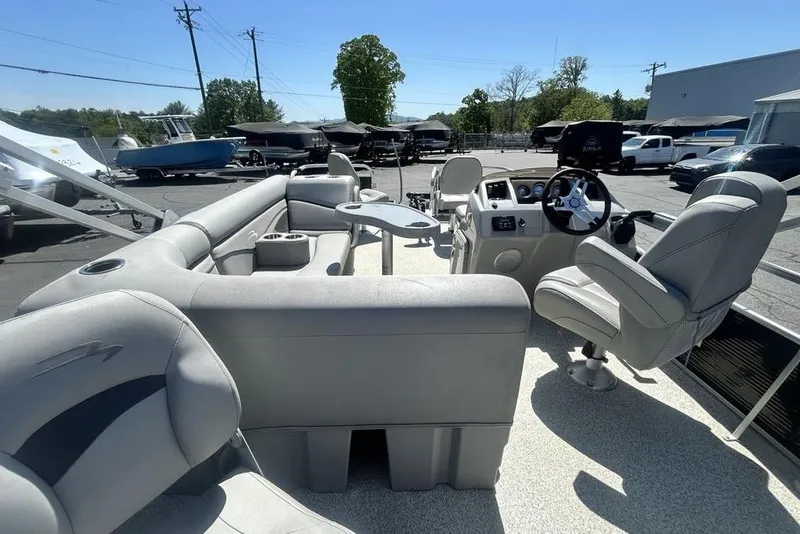 Slide: The Image of 2021 Bennington 20 SFX pontoon boat interior with plush seating and steering console. - 6