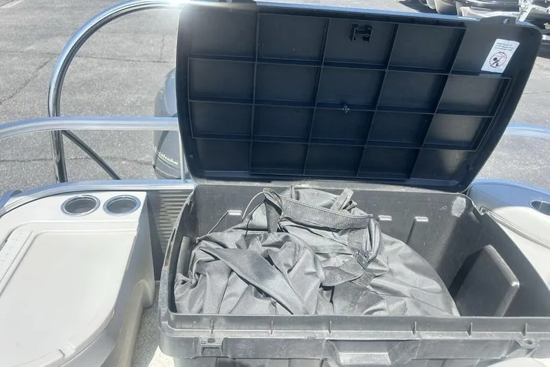 Slide: The Image of Open storage compartment on 2021 Bennington 20 SFX boat with black cover inside. - 7