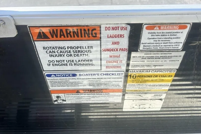 Slide: The Image of Warning labels on a 2021 Bennington 20 SFX boat, highlighting safety precautions. - 9