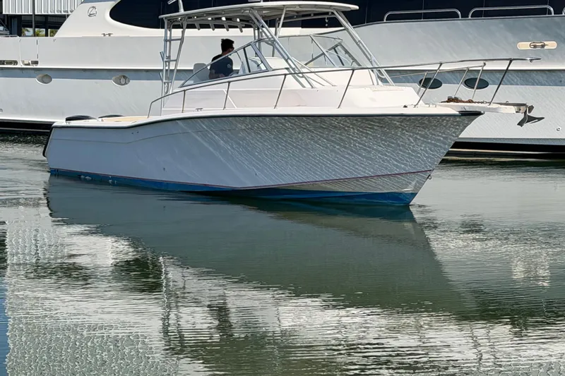 The Image of 1996 Grady-White Marlin 300 boat docked on calm water. - 1